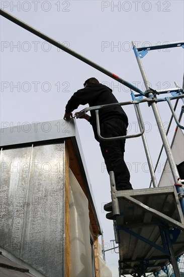 Roofer working on a new dormer window (model relased)