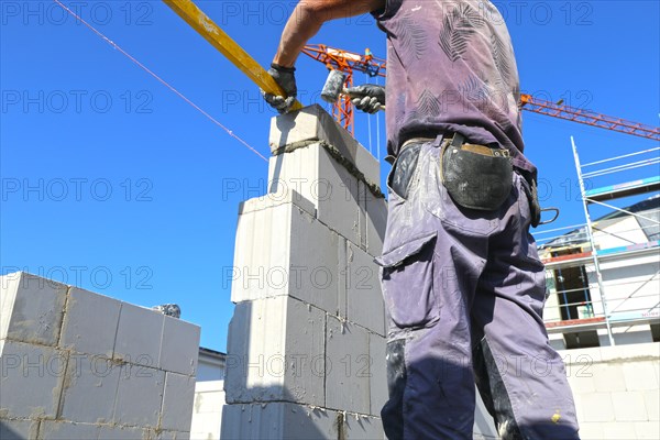 Construction worker (bricklayer) on the building site