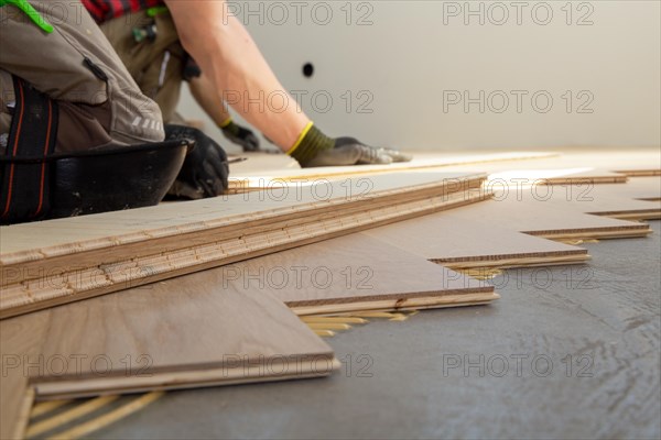 Craftsmen laying herringbone parquet professionally