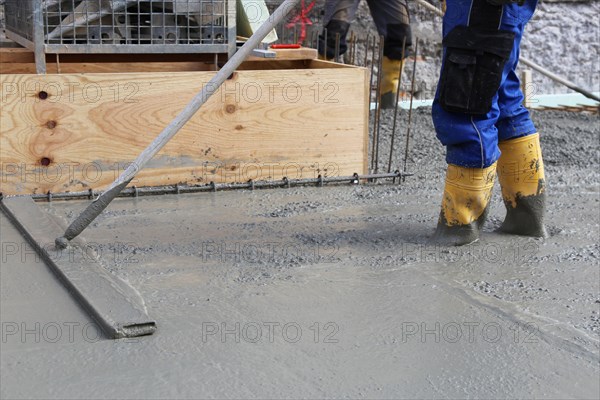 Concreting a floor slab with ready-mixed concrete on the construction site of a residential building