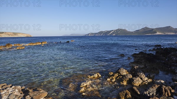 Clear view of the calm sea with rocky coast and mountains in the distance on the horizon, sea fortress Methoni, Peloponnese, Greece, Europe