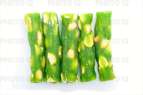 Green traditional turkish delight (rahat lokum) with peanuts isolated on white background. top view, flat lay, close up