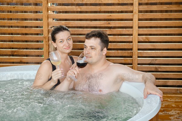Couple enjoys vacation and taking outdoor hot tub together