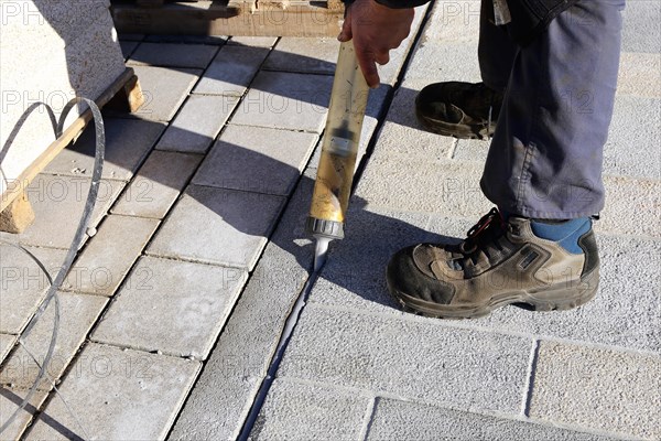 Worker lays paving stones