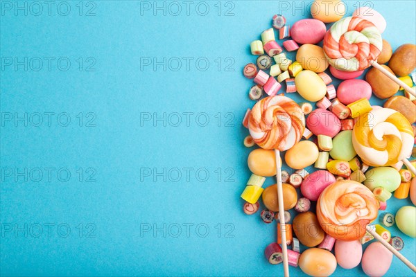 Various caramel candies on blue pastel background. copy space, top view, flat lay