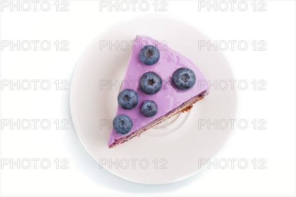 Homemade cake with souffle cream and blueberry jam isolated on white background. top view