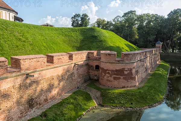 Ancient restored castle with a moat in the Nesvizh city. Belarus