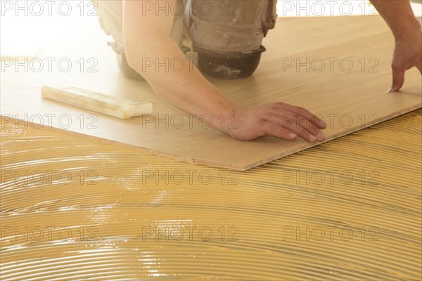 Craftsmen laying herringbone parquet professionally