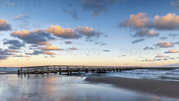 Sunrise at the pier of zingst during an icy storm as a long exposure