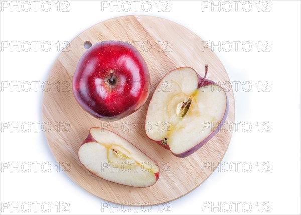 Sliced red apples on wooden board isolated on white background. closeup. top view