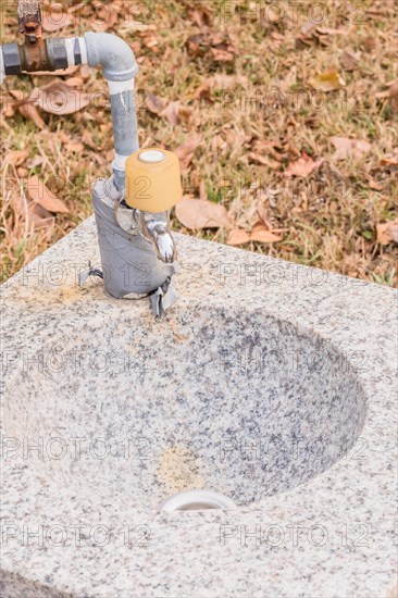 Closeup of outdoor water faucet and basin in public park in South Korea