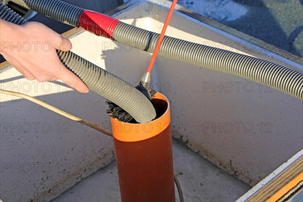 Workers from Abfluss AS clean the exhaust air ducts in an apartment block in Mannheim