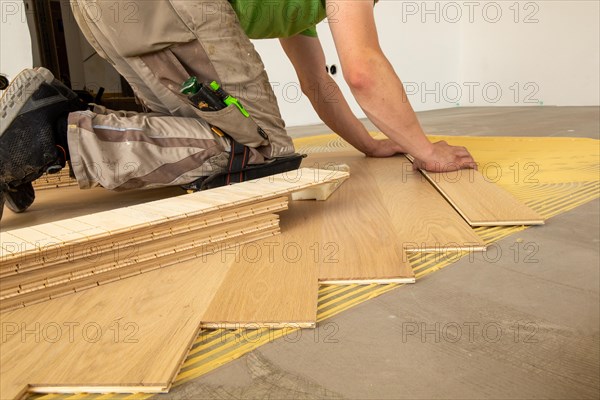 Craftsmen laying herringbone parquet professionally