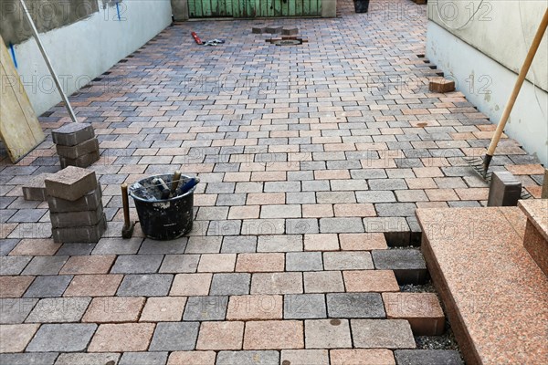 Worker lays paving stones