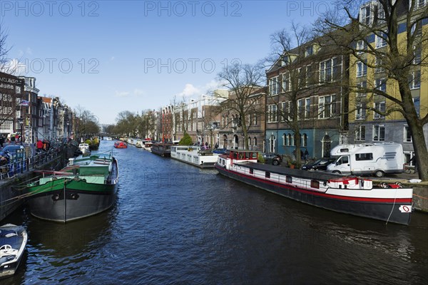 Boats in the canal, city tour, tourism, city trip, holiday, travel, city exploration, centre, Amsterdam, Netherlands