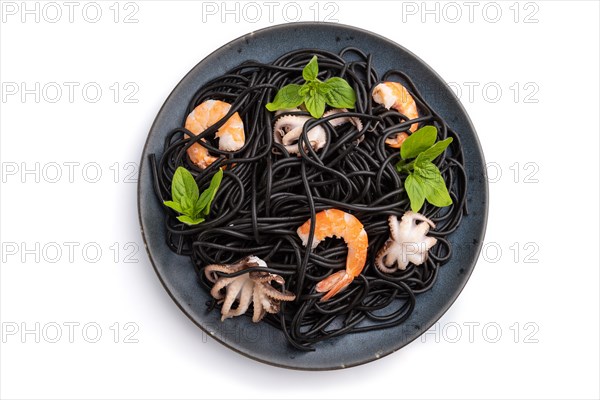 Black cuttlefish ink pasta with shrimps or prawns and small octopuses isolated on white background. Top view, flat lay, close up