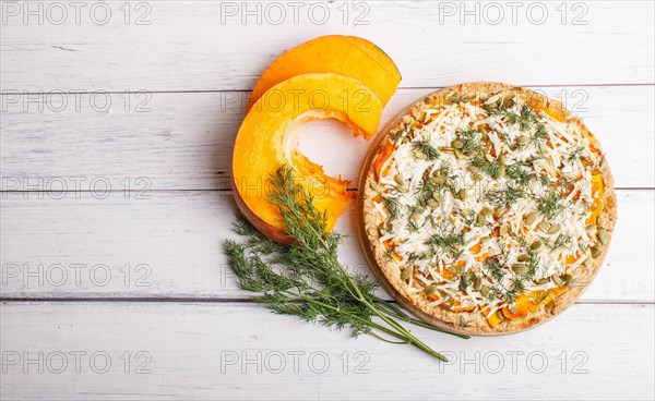 Sweet pumpkin pie with cheese and dill on white wooden background. top view. copy space