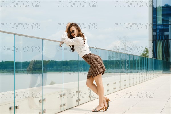 Smiling young woman standing on observation deck
