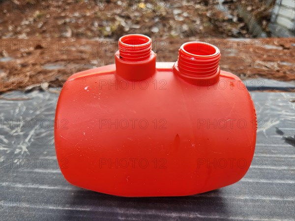 Orange plastic water tank for toy water gun with blurred background in South Korea