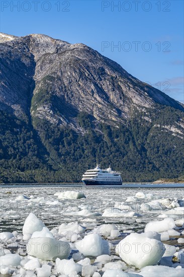 Cruise ship Stella Australis anchored between ice floes in Pia Bay in front of the Pia Glacier, Alberto de Agostini National Park, Avenue of the Glaciers, Chilean Arctic, Patagonia, Chile, South America