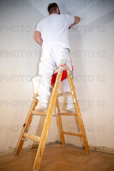 Painter renovates an old flat