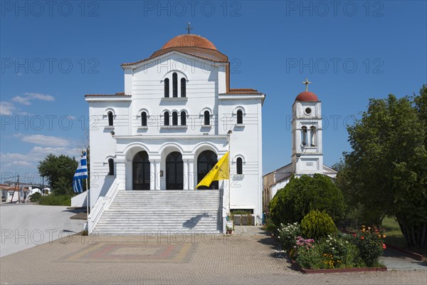 An imposing whitewashed church with a red roof and bell tower on a sunny day, Greek Orthodox Church of the Transfiguration of the Saviour, Porto Lagos, Xanthi, Eastern Macedonia and Thrace, Greece, Europe