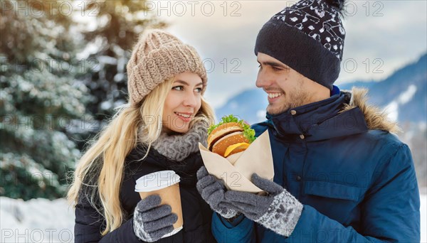 AI generated, human, humans, person, persons, man, woman, woman, two persons, 25, 30, years, couple, outdoor, ice, snow, winter, seasons, eats, eating, hat, bobble hat, gloves, winter jacket, cold, cold, burger, hamburger