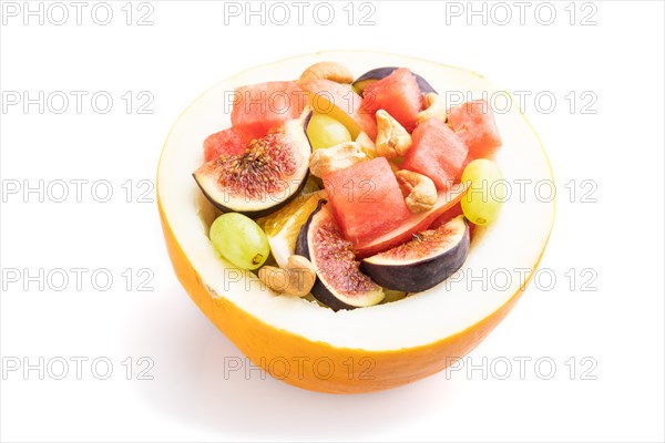 Vegetarian fruit salad of watermelon, grapes, figs, pear, orange, cashew isolated on white background. Side view, close up
