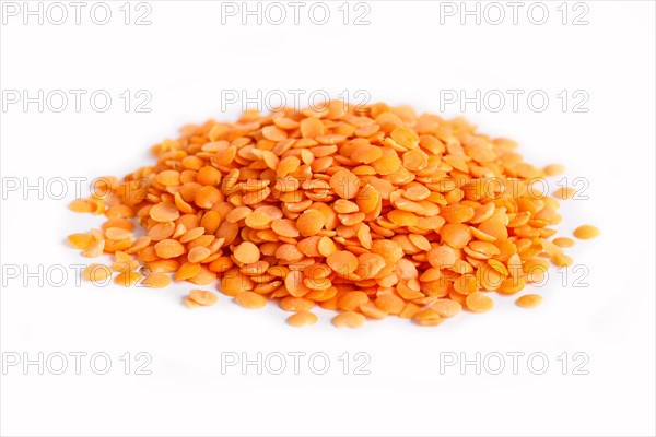 Pile of red lentils isolated on white background. Closeup