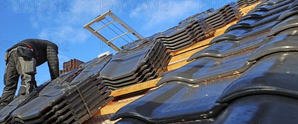 Panoramic image of the roof covering of a new tiled roof on a residential building