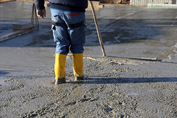 Concreting a floor slab with ready-mixed concrete on the construction site of a residential building