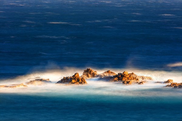 The sea washes around an offshore reef, long exposure, La Crucecita, Baja de Huatulco, South Pacific Coast, State of Oaxaca, Mexico, Central America