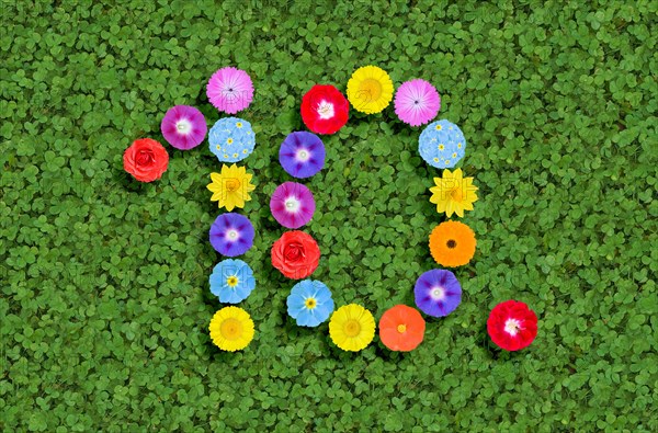 Number 10th 10 ten tenth written with colorful flowers on green clover background
