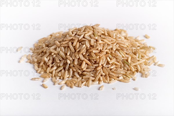 Pile of brown rice isolated on white background. Closeup
