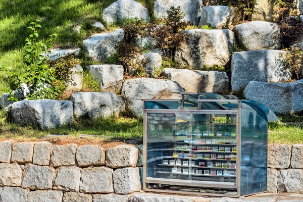 Prayer candles in glass cabinet on stone ledge in church countryside park in South Korea