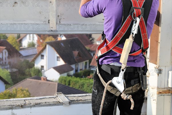 Roofer with fall protection