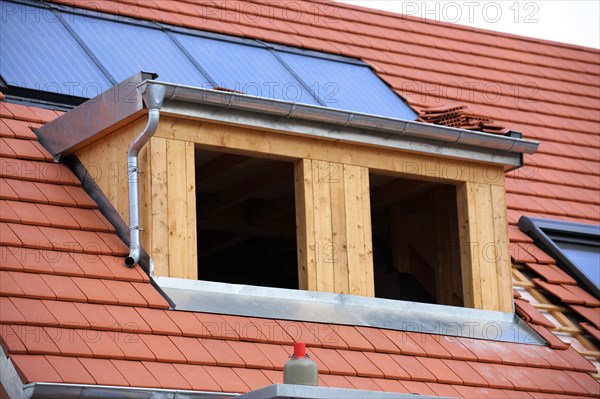 Roofer working on a new dormer window