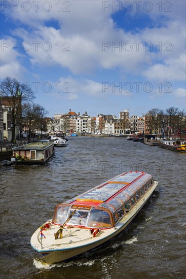 Canal cruise with typical tourist boat, tour, canal tour, city tour, tourism, city trip, holiday, travel, city exploration, city tour, centre, Amsterdam, Netherlands