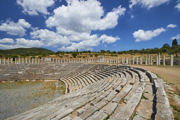 Ancient stadium with rows of seats and wild grass under a cloudy sky, archaeological site, Ancient Messene, capital of Messinia, Messini, Peloponnese, Greece, Europe