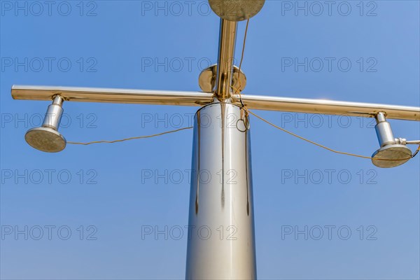 Closeup of chrome public shower sprinklers in rural park against clear blue sky in South Korea