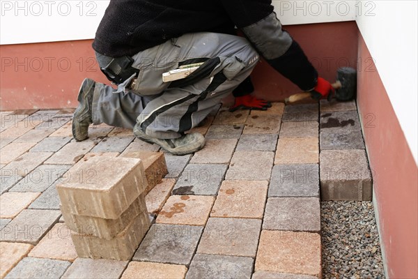 Worker lays paving stones