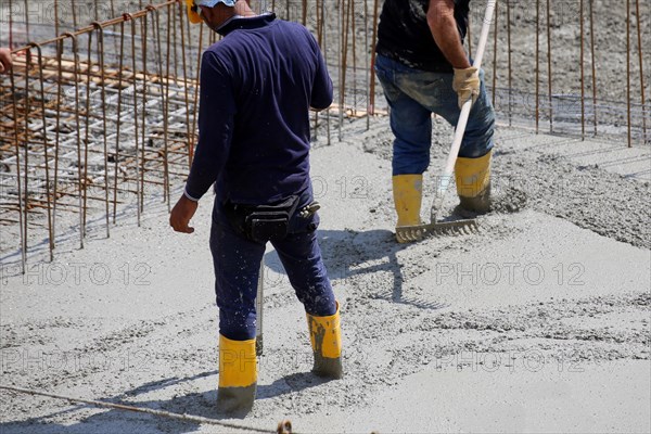 Concreting a floor slab with ready-mixed concrete on the construction site of a residential building