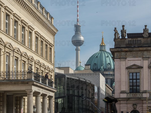 View of historic buildings in the foreground with the Berlin television tower in the background under a clear sky Several architectural styles at a glance Berlin