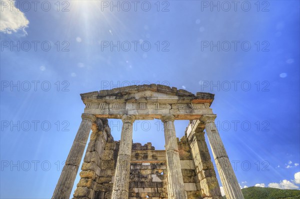 Sky-blue background behind the imposing remains of an ancient temple, Mausoleum, Heroon, Archaeological site, Ancient Messene, Capital of Messinia, Messini, Peloponnese, Greece, Europe
