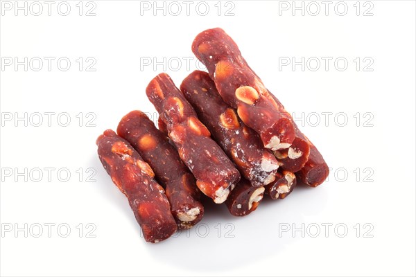 Brown traditional turkish delight (rahat lokum) with peanuts isolated on white background. side view, close up