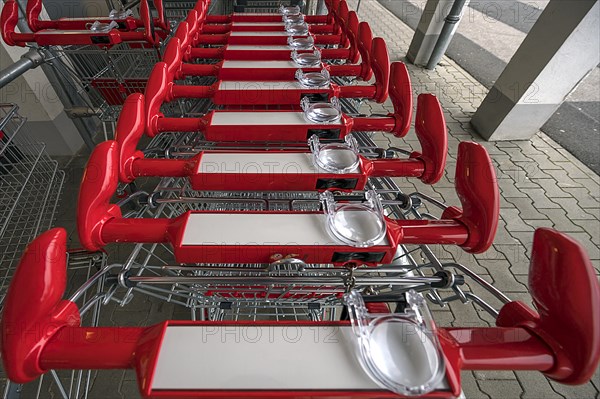 Shopping trolley with magnifying glass in front of a supermarket, Bavaria, Germany, Europe