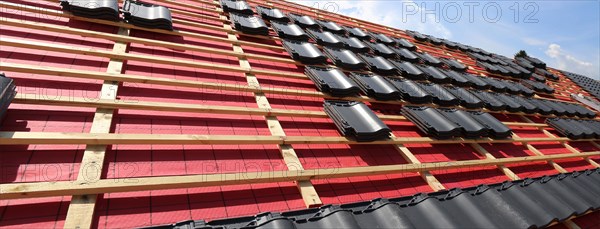 Panoramic image of the roof covering of a new tiled roof on a residential building