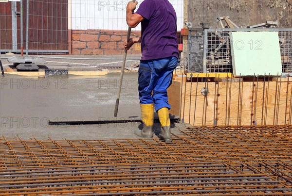 Concreting a floor slab with ready-mixed concrete on the construction site of a residential building