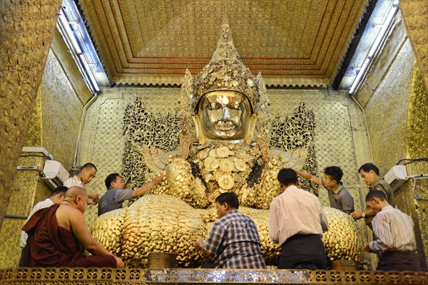 Local people praying, Saint Golden Buddha in the Mahamuni Pagoda, Mandalay, Myanmar, Asia