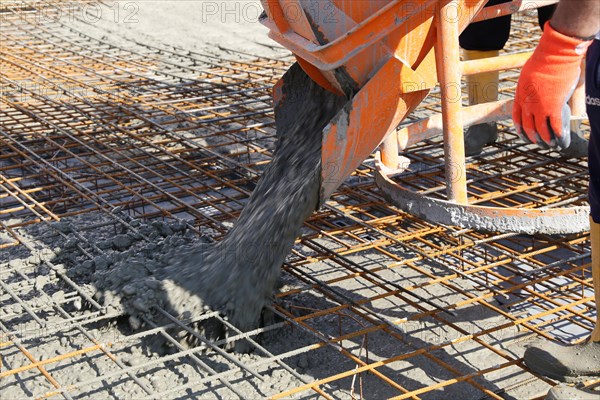 Concreting a floor slab with ready-mixed concrete on the construction site of a residential building